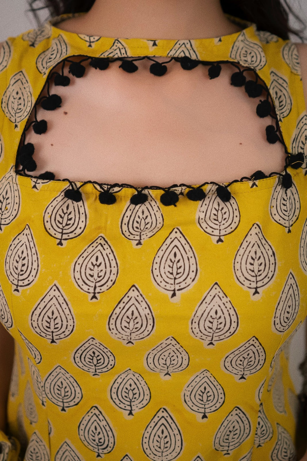 Sonam Yellow Printed  Sleeveless Straight Kurti.